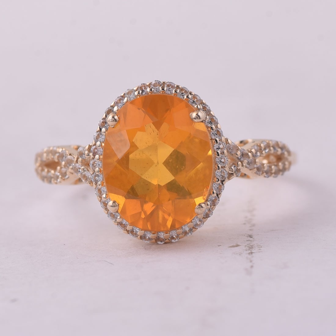 2.09 Ct Oval Br.Fire Opal 9K Gold Ring: 2.09 Total Carat Br.Fire Opal 9K Gold Ring Specifications: Total Weight 2.2 g Center Gemstone Br.Fire Opal Gemstone Carat Weight 1.83 Carats Gemstone Measurements 10X8 mm Additional Gemstones White Sa