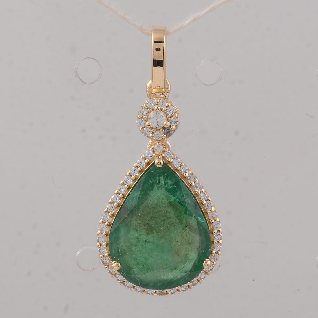 3.41 Ct Pear Emerald 9K Gold Pendant: 3.41 Total Carat Emerald 9K Gold Pendant Specifications: Total Weight 1.75 g Center Gemstone Emerald Gemstone Carat Weight 3.2 Carats Gemstone Measurements 12.50X9.80X4.50 mm Additional Gemstones
