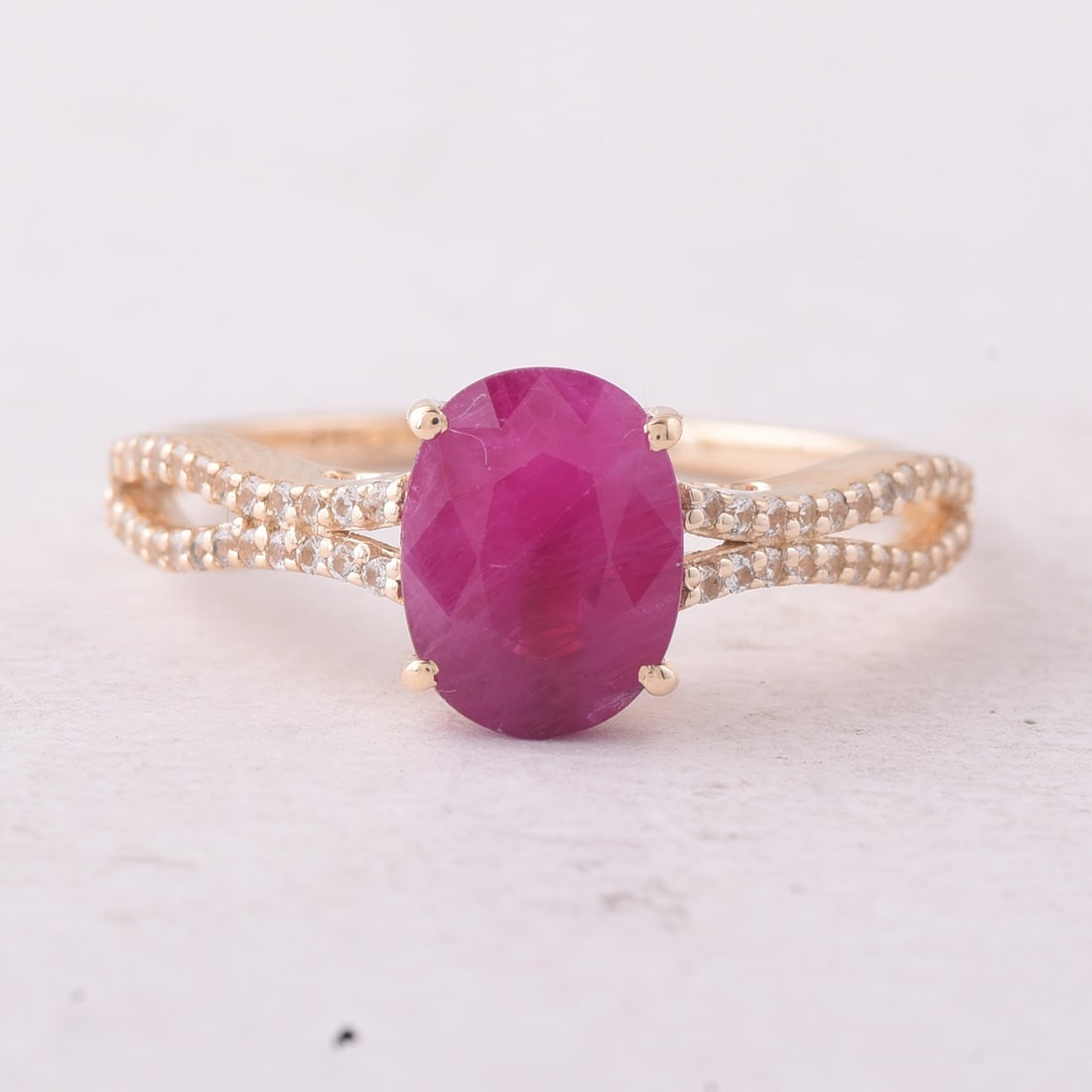 2.34 Ct Oval Ruby 9K Gold Ring: 2.34 Total Carat Ruby 9K Gold Ring Specifications: Total Weight 2.053 g Center Gemstone Ruby Gemstone Carat Weight 2.12 Carats Gemstone Measurements 8.50X6.50X4.50 mm Additional Gemstones White