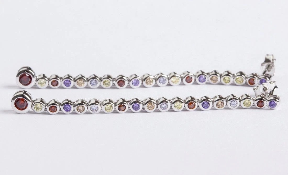 Sterling Silver Multi Colored Cubic Zirconia Dangle Earrings: Title:Sterling Silver Multi Colored Cubic Zirconia Dangle Earrings Description:Long and dangle sterling silver earrings with several colored cubic zirconia. Dead stock vintage. Circa 1980’s. The