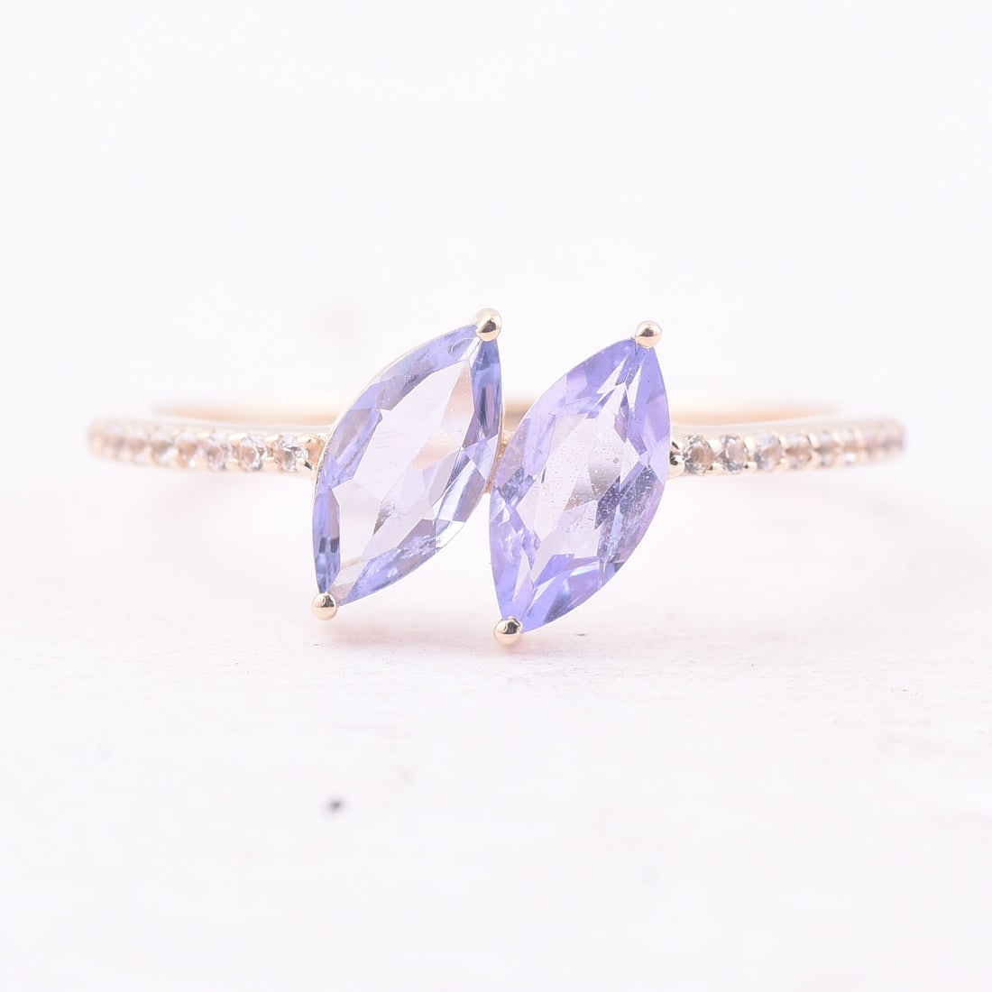 0.93 Ct Marquise Tanzanite 9K Gold Ring: 0.93 Total Carat Tanzanite 9K Gold Ring Specifications: Total Weight 1.499 g Center Gemstone Tanzanite Gemstone Carat Weight 0.85 Carats Gemstone Measurements 8X4 mm Additional Gemstones White