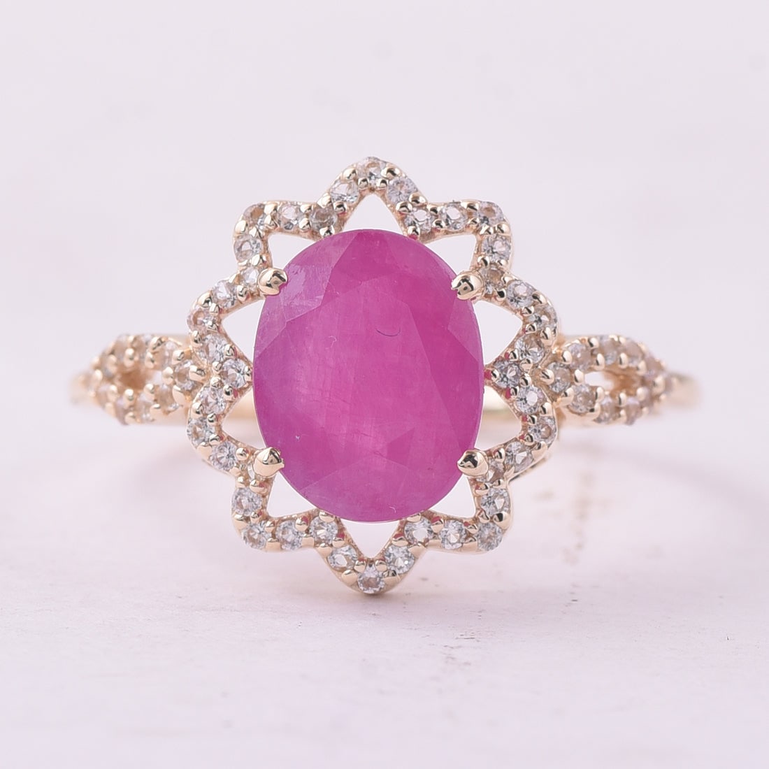2.58 Ct Oval Ruby 9K Gold Ring: 2.58 Total Carat Ruby 9K Gold Ring Specifications: Total Weight 2.076 g Center Gemstone Ruby Gemstone Carat Weight 2.31 Carats Gemstone Measurements 9X7 mm Additional Gemstones White Sapphire