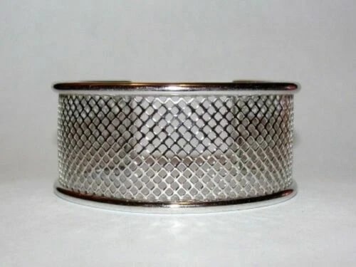 Sterling Silver Fish Net Cut Out Cuff Bracelet: Title:Sterling Silver Fish Net Cut Out Cuff Bracelet Description:Very practical and wearable. Even unisex! Circa 1970's to 1980's. Sterling silver fish net design cuff bracelet. Measures 1 1/4" wide.