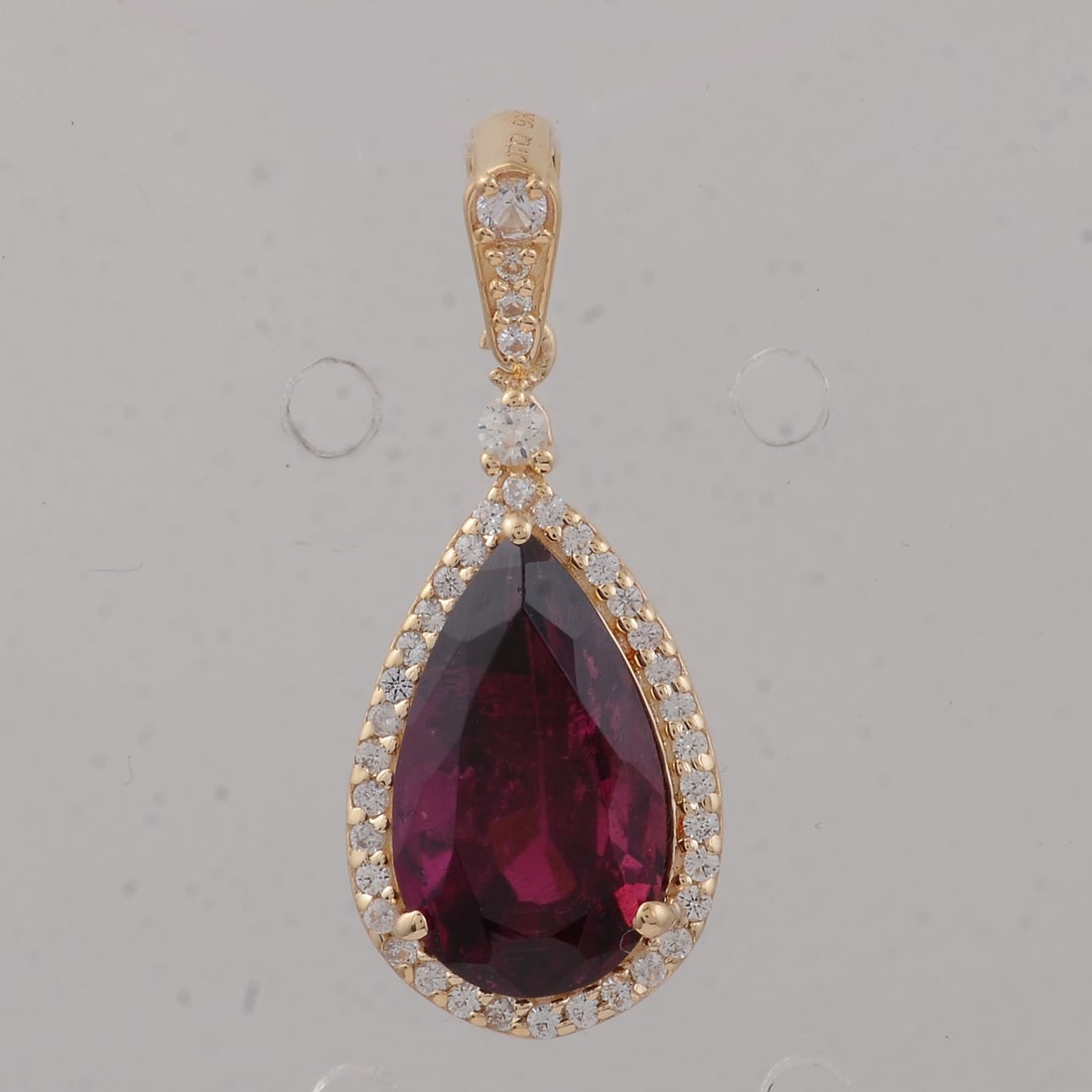 2.95 Ct Pear Rubellite 9K Gold Pendant: 2.95 Total Carat Rubellite 9K Gold Pendant Specifications: Total Weight 1.39 g Center Gemstone Rubellite Gemstone Carat Weight 2.72 Carats Gemstone Measurements 12X7X5.50 inch Additional Gemstones