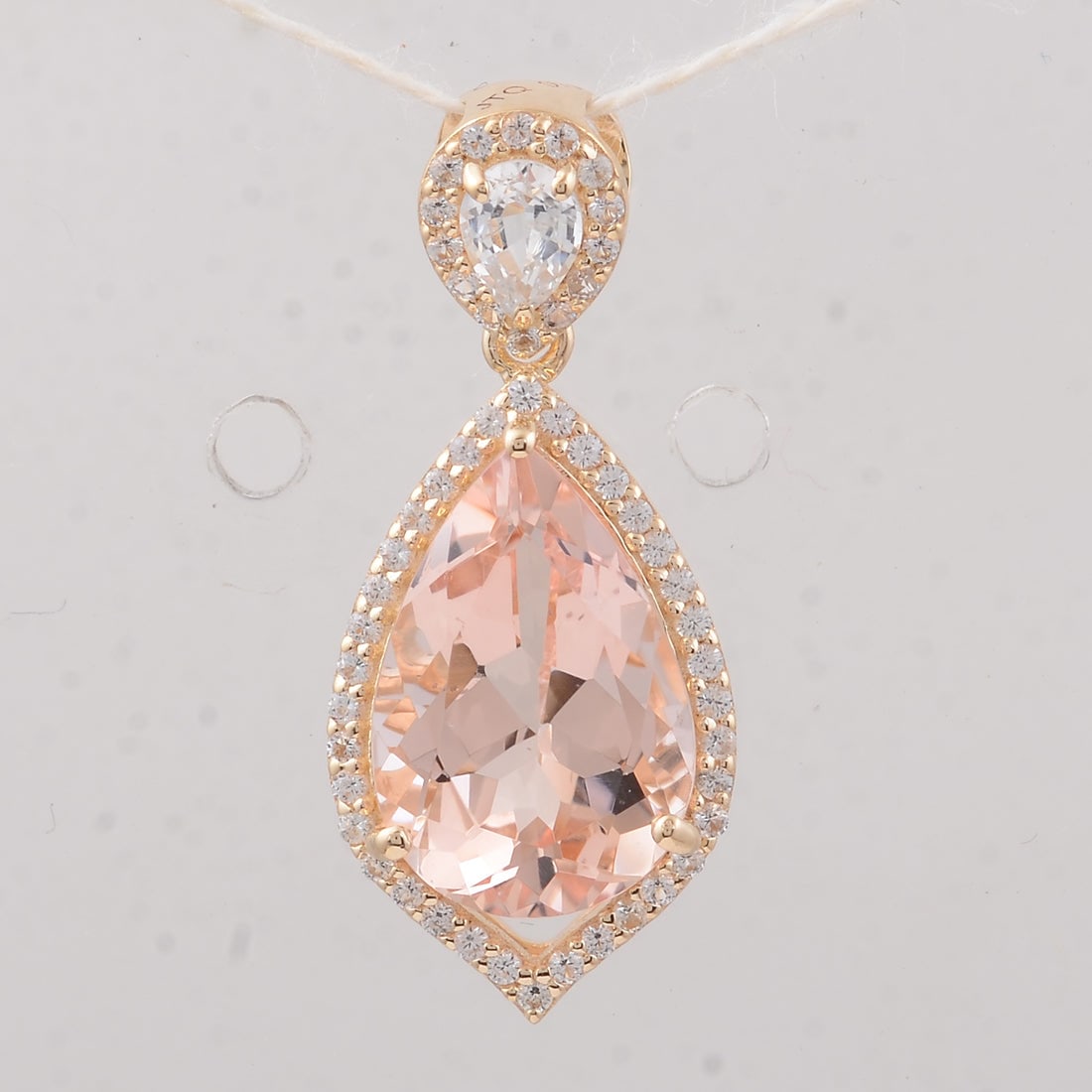 3.31 Ct Pear Morganite 9K Gold Pendant: 3.31 Total Carat Morganite 9K Gold Pendant Specifications: Total Weight 1.87 g Center Gemstone Morganite Gemstone Carat Weight 2.87 Carats Gemstone Measurements 12X8X5.70 mm Additional Gemstones