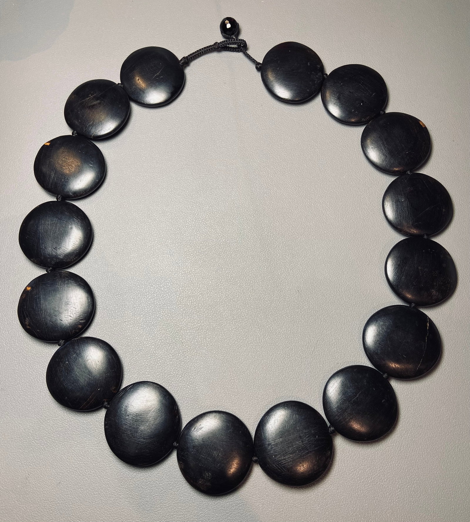 Huge Black Ebony Disc Beads African Tribal Statement Necklace: Title: Huge Black Ebony Disc Beads African Tribal Statement Necklace Description:Experience the captivating allure of heritage with this Vintage Large Black Ebony Disc Beads Africa Tribal Statement
