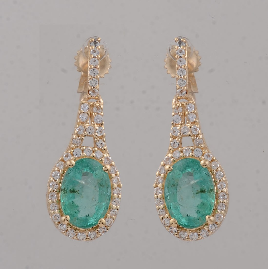 2.10 Ct Oval Emerald 9K Gold Earrings: 2.10 Total Carat Emerald 9K Gold Earrings Specifications: Total Weight 2.065 g Center Gemstone Emerald Gemstone Carat Weight 1.79 Carats Gemstone Measurements 7X5 inch Additional Gemstones White