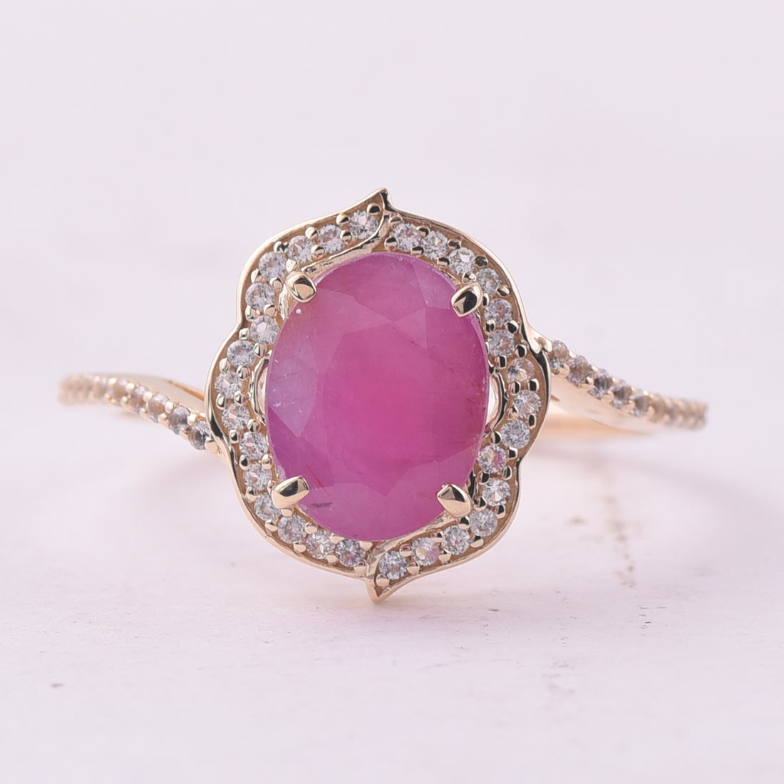 2.60 Ct Oval Ruby 9K Gold Ring: 2.60 Total Carat Ruby 9K Gold Ring Specifications: Total Weight 2.191 g Center Gemstone Ruby Gemstone Carat Weight 2.38 Carats Gemstone Measurements 9X7 mm Additional Gemstones White Sapphire Addition