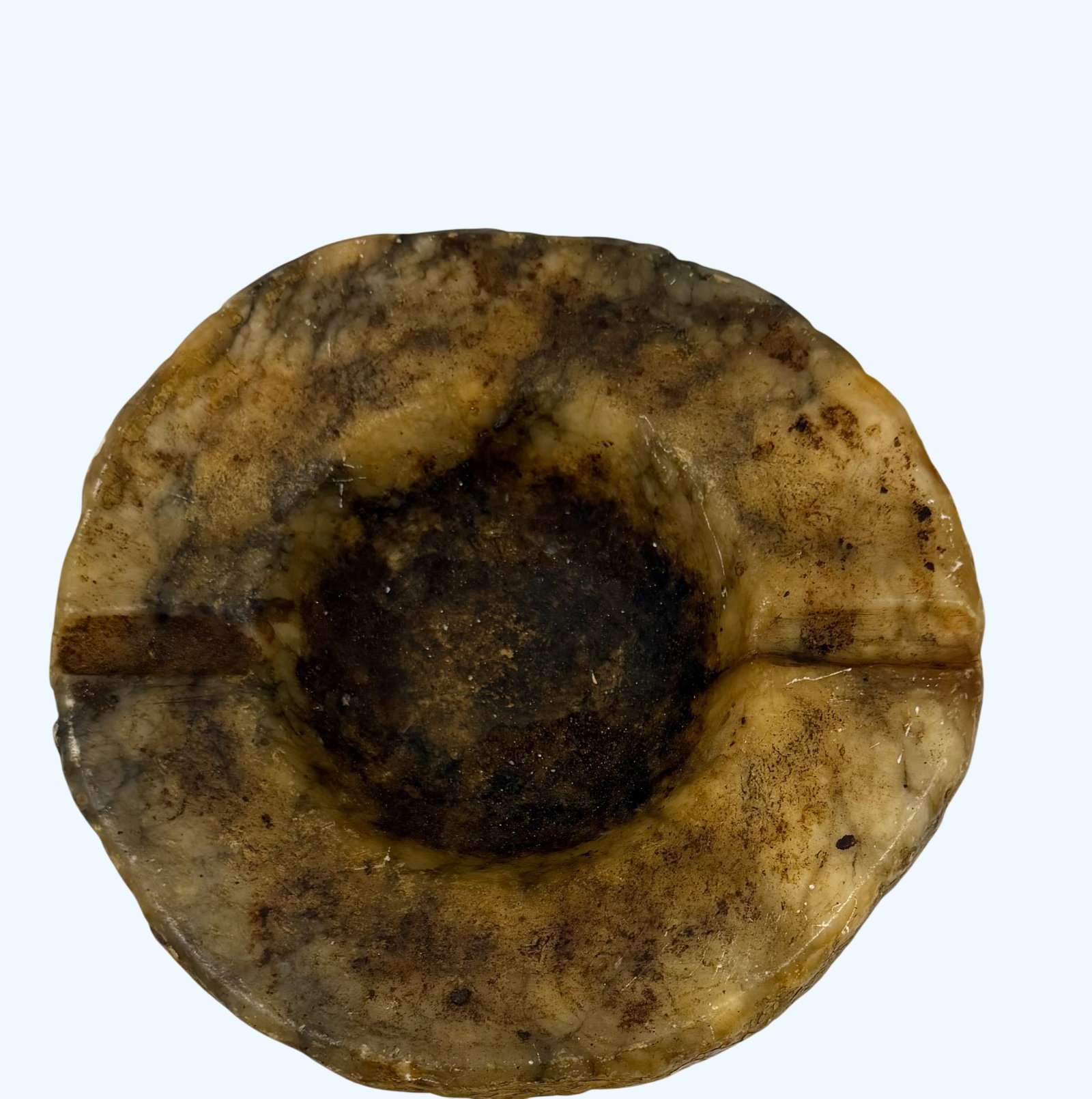 Vintage Alabaster Ashtray: This vintage ashtray is crafted from carved alabaster, showcasing natural variations in its translucent, creamy beige and brown hues. The circular form features a central depression for ash