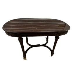 Carved Regency-Style Mahogany Side Table: This elegant Regency-style side table is crafted from mahogany, featuring a rich, dark finish. The oval top showcases a subtle, swirled wood grain pattern and a finely carved edge with repeating