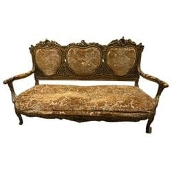 Giltwood and Upholstered Rococo Style Settee: This ornate giltwood settee, crafted in the Rococo style, features a richly carved frame with scrolling motifs and floral accents. The backrest is divided into three heart-shaped panels, each upholste
