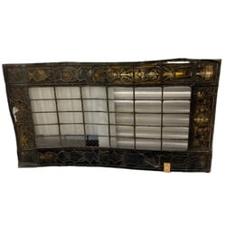 Large Neo-Gothic Stained Glass Window Panel: A substantial Neo-Gothic stained glass window panel, likely dating from the late 19th or early 20th century. The central portion features clear, textured glass in a grid pattern, creating a subtle
