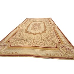 Large-Scale Neoclassical Style Aubusson Style Carpet, 20th Century: This large carpet, in the Aubusson style, features a neoclassical design with a central oval medallion enclosing a dense floral bouquet. The medallion is surrounded by an expansive field adorned with 