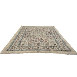 Hand-Knotted Persian Wool and Silk Area Rug: This exquisite hand-knotted Persian rug features a central medallion design with intricate floral and vine motifs, characteristic of traditional Persian weaving. The field and borders are adorned