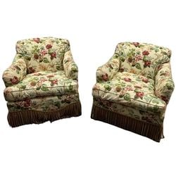 Pair of William & Collins Floral Upholstered Swivel Armchairs: This lot features a pair of traditional style swivel armchairs from William & Collins, upholstered in a vibrant floral fabric. The fabric showcases an all-over pattern of blooming roses and other bota
