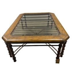 Leather-Wrapped Cocktail Table with Glass Top and Barley Twist Legs: An elegantly designed cocktail table featuring a rectangular form with clipped corners. The top is wrapped in a rich, warm brown leather with decorative gold tooling along the edges, framing a