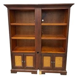 Pair of Hardwood Bookcases with Woven Rattan Cabinet Doors: This lot features a pair of hardwood bookcases, likely crafted from mahogany or a similar rich-toned wood, showcasing a transitional style that blends classic and contemporary elements. Each bookcase