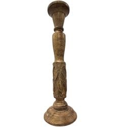 Carved Wooden Candlestick: A single turned and carved wooden candlestick, likely 20th century. The candlestick features a wide, circular foot, a turned base, a central shaft with carved leaf motif, and a turned top designed to