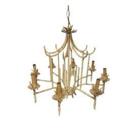 Chic Faux Bamboo Chandelier in Chinoiserie Style: This elegant chandelier features a faux bamboo motif, characteristic of the Chinoiserie style. Crafted from painted metal in an off-white finish, it evokes a stylish, exotic aesthetic. The chandelier