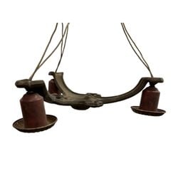 Antique Three-Light Chandelier: This antique three-light chandelier features a cast metal frame with an ornate central finial and three arms, each terminating in a brass-colored light socket with a fluted edge. The current sockets