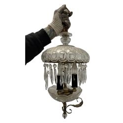 Vintage Crystal and Brass Two-Tier Chandelier: This vintage two-tier chandelier features a top tier with pressed glass in a circular motif, adorned with numerous hanging crystal prisms. The lower tier consists of a fluted glass bowl. The frame