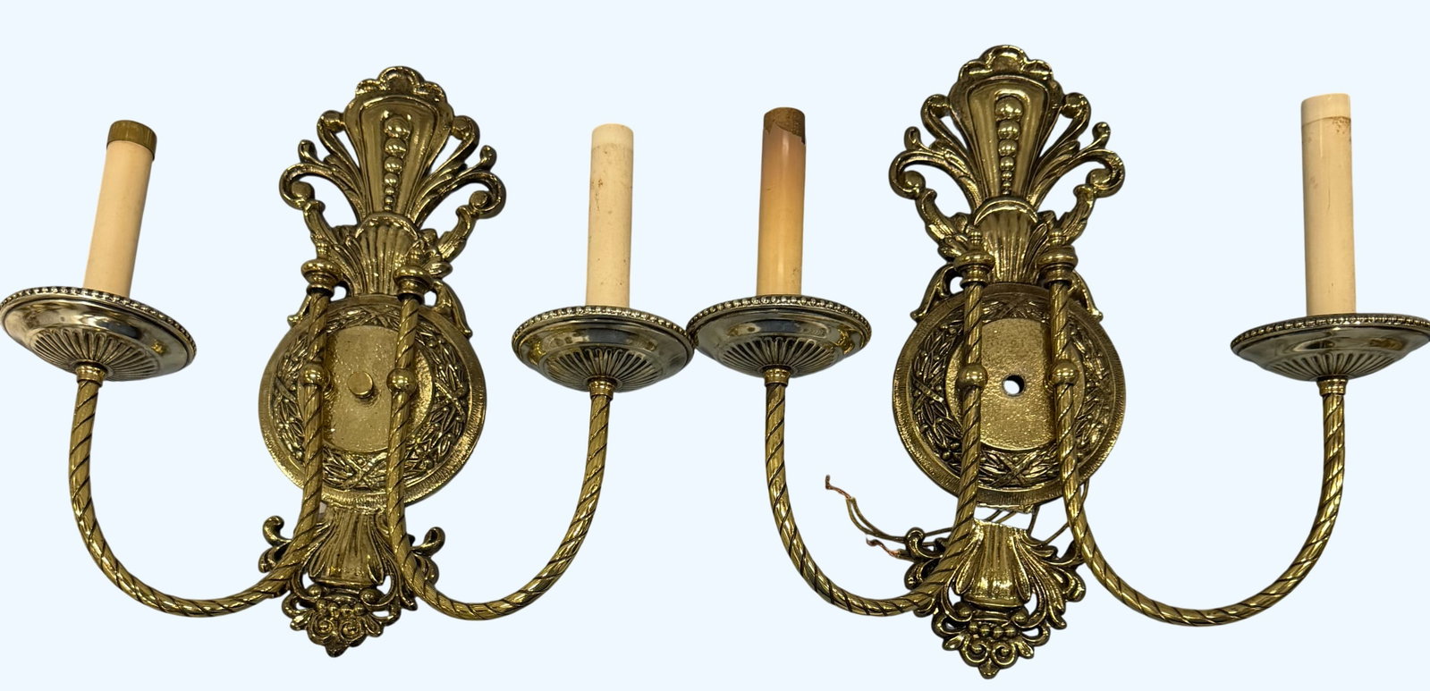 Pair of Ornate Gilt Brass Double-Arm Wall Sconces: This is an elegant pair of Neoclassical style gilt brass wall sconces, each featuring a decorative backplate with shell and acanthus leaf motifs. Each sconce supports two gracefully curved arms