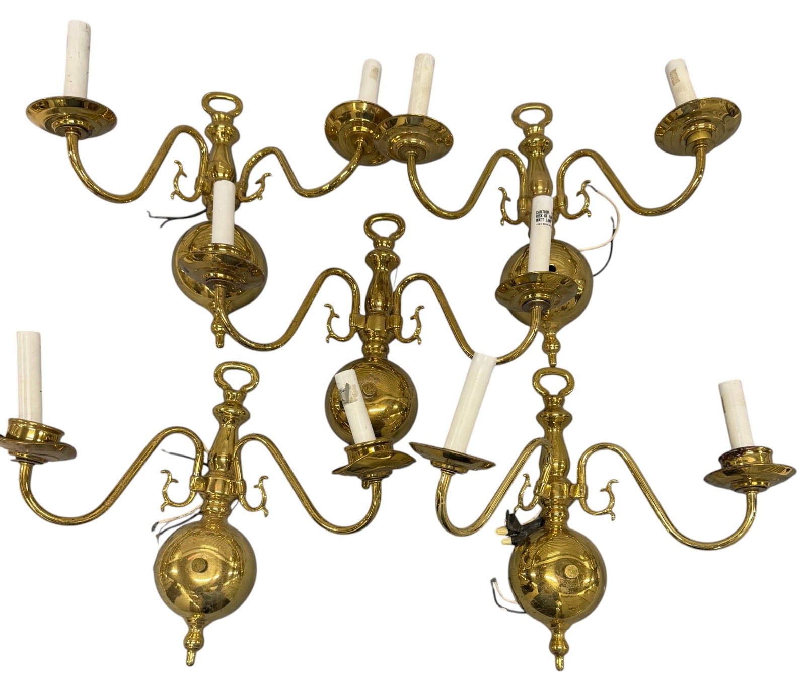 Set of Five Gilt Brass Double-Arm Sconces: A set of five matching gilt brass double-arm sconces, likely dating to the mid-20th century, offering a blend of traditional and federal styles. Each sconce features a central urn-form finial from