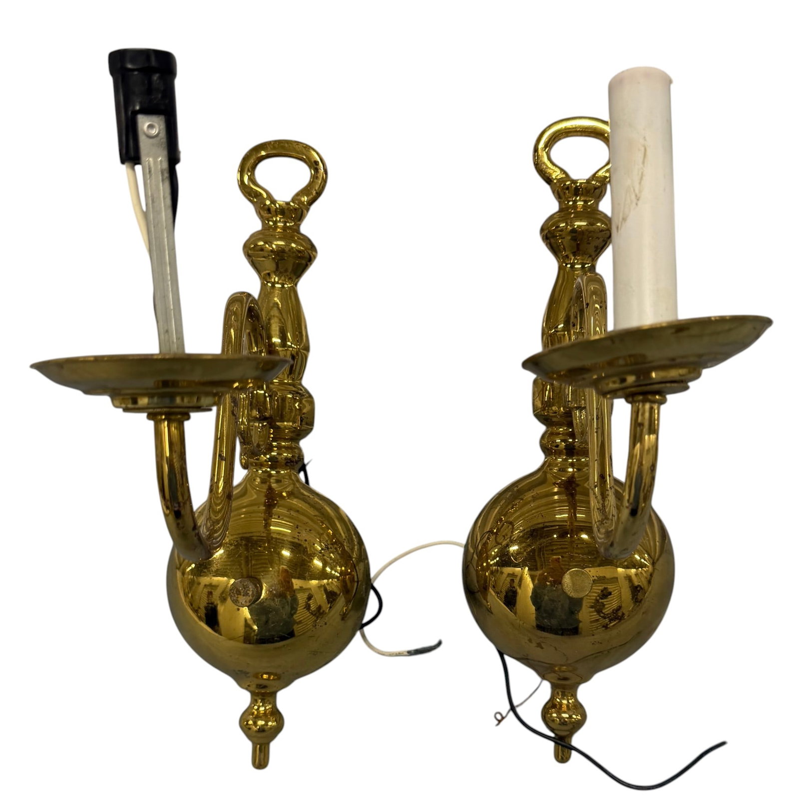 Pair of Polished Brass Wall Sconces: A pair of polished brass wall sconces, likely mid-20th century, featuring a traditional Colonial Revival or Federal style. Each sconce is designed with a rounded, bulbous body tapering to a finial at