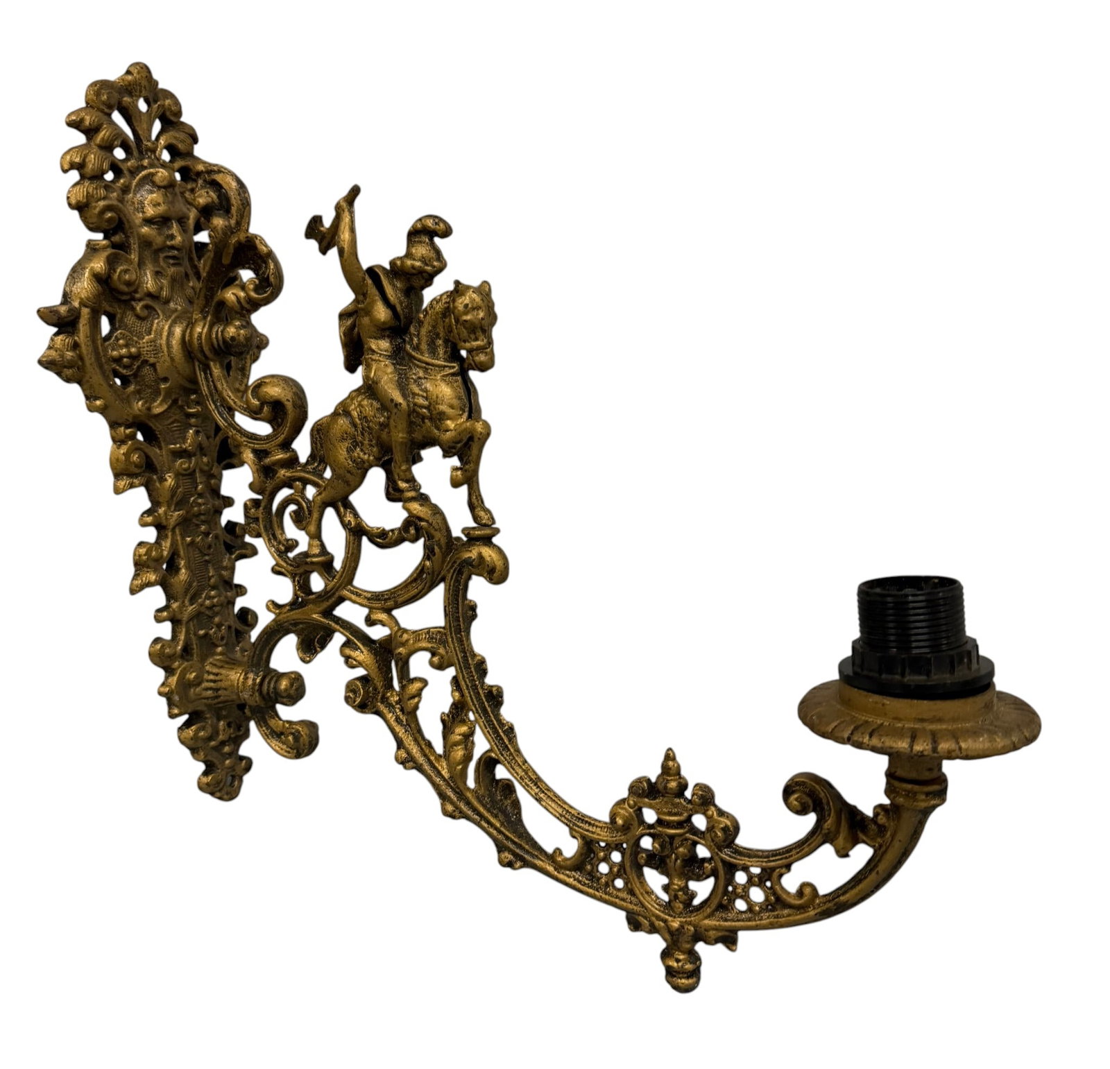 Gilt Metal Sconce with Mounted Cavalier Motif: This ornate gilt metal sconce features a martial motif popular in the Baroque Revival style. The central design depicts a cavalier mounted on a spirited horse, brandishing a weapon, set against a