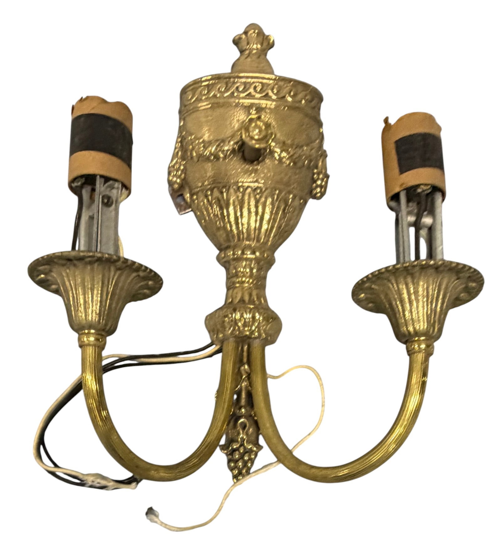 Pair of Louis XVI Style Gilt Bronze Two-Light Sconces: A pair of Louis XVI style gilt bronze two-light sconces, likely early 20th century. Each sconce features an urn-form backplate adorned with classical motifs including a central rosette flanked by
