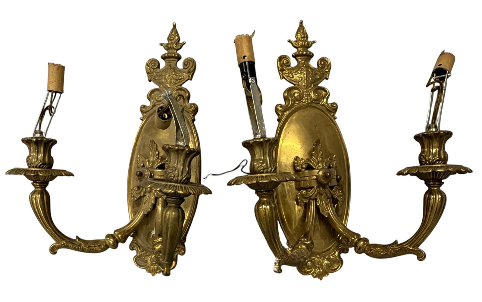 Pair of Rococo Revival Gilt Bronze Two-Light Sconces: A pair of Rococo Revival two-light sconces crafted from gilt bronze. Each sconce features an oval backplate elaborately decorated with acanthus leaves, scrolls, and rocaille motifs characteristic of