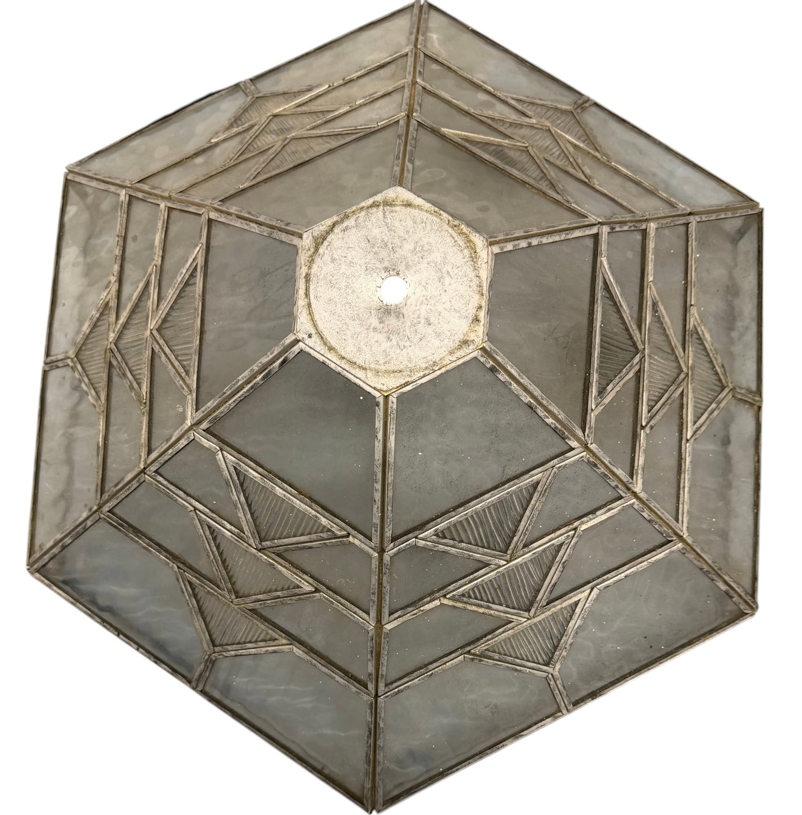 Art Deco Stained Glass Hexagonal Lampshade: This authentic Art Deco hexagonal lampshade features a striking geometric design crafted from various translucent and clear stained glass panels, held in a soldered metal frame. The clear panels are