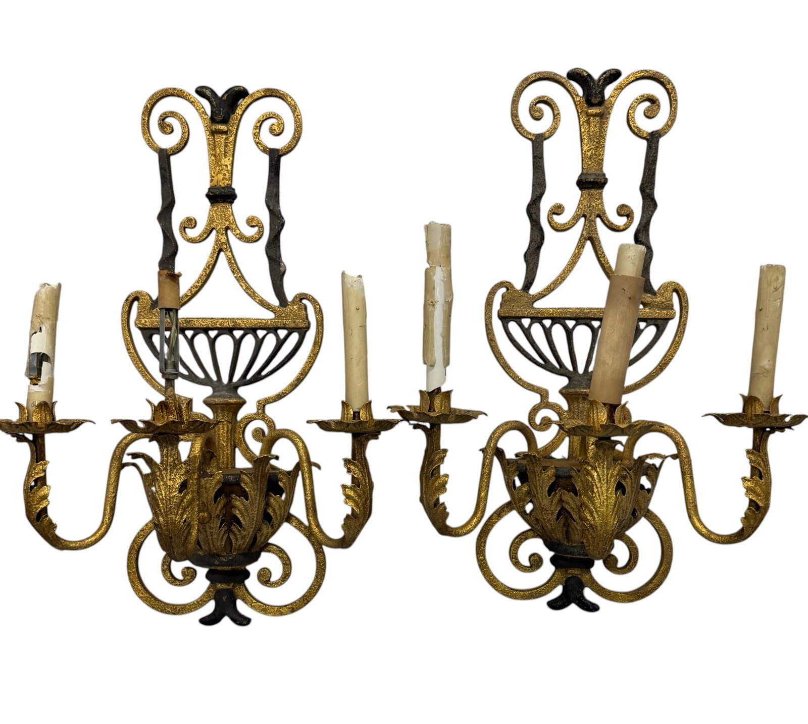 Pair of Gilt and Wrought Iron Sconces, Neoclassical Style: A striking pair of gilt and wrought iron wall sconces, crafted in the Neoclassical style. Each sconce features an elaborately scrolled and pierced backplate, finished in a combination of darkened