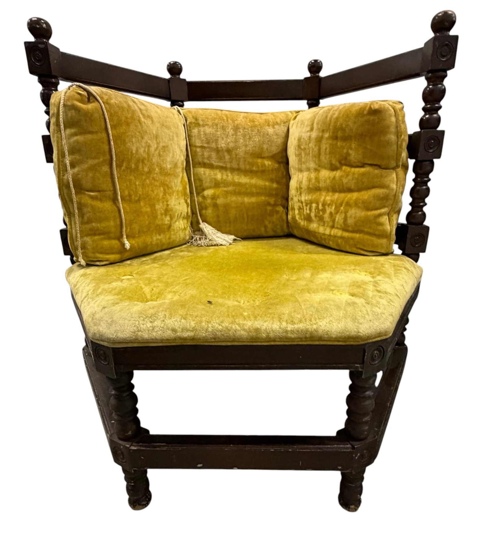Victorian Style Corner Chair with Chartreuse Velvet Upholstery: This Victorian-style corner chair features dark stained, possibly walnut or mahogany, turned and carved wood framing. The chair is upholstered in a vibrant chartreuse velvet, with tufted seat and back