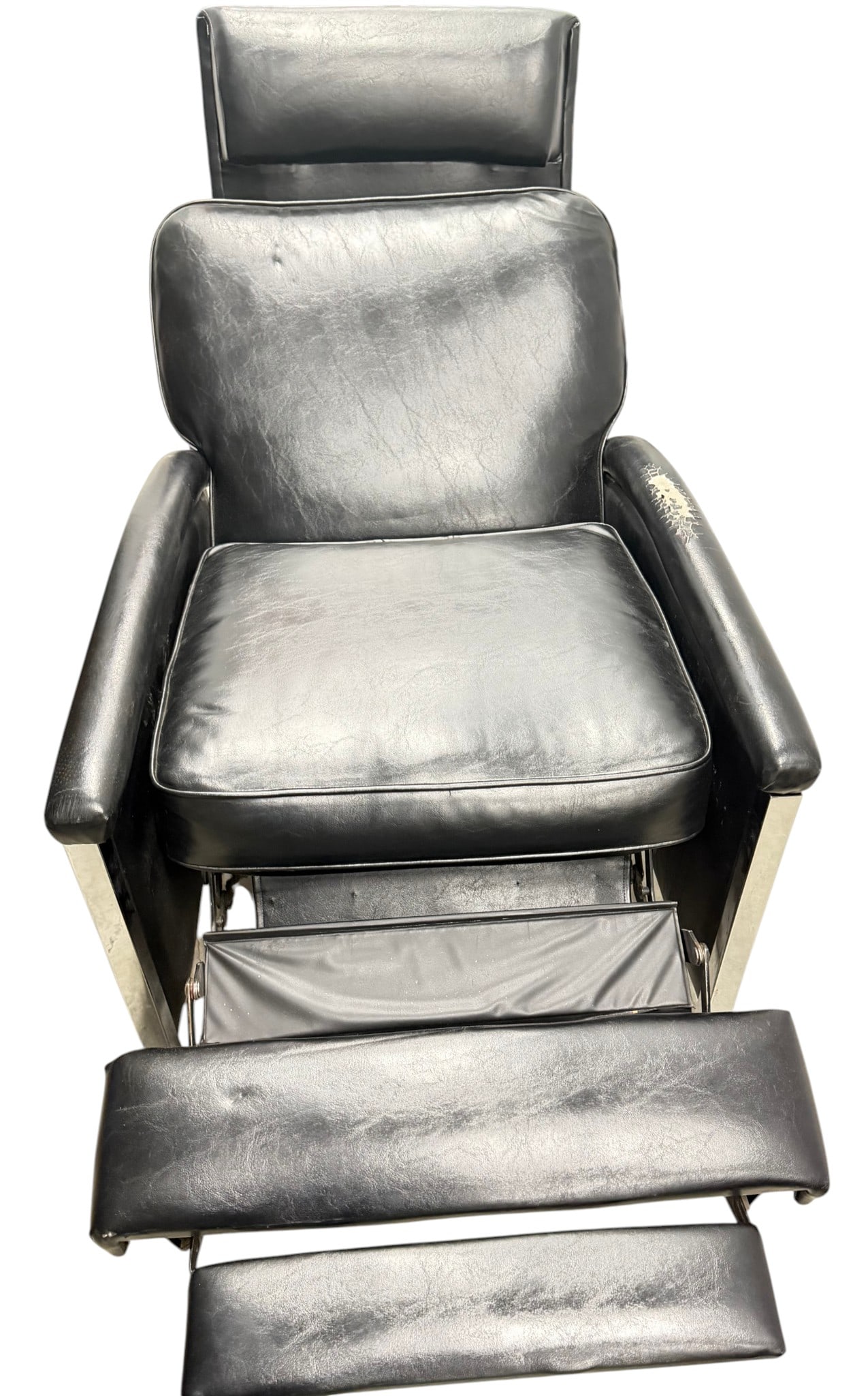 Mid-Century Modern Black Vinyl and Chrome Recliner: A stylish Mid-Century Modern recliner featuring black vinyl upholstery and a polished chrome frame. The chair has a sleek, minimalist design with padded armrests and integrated footrest. This piece ex