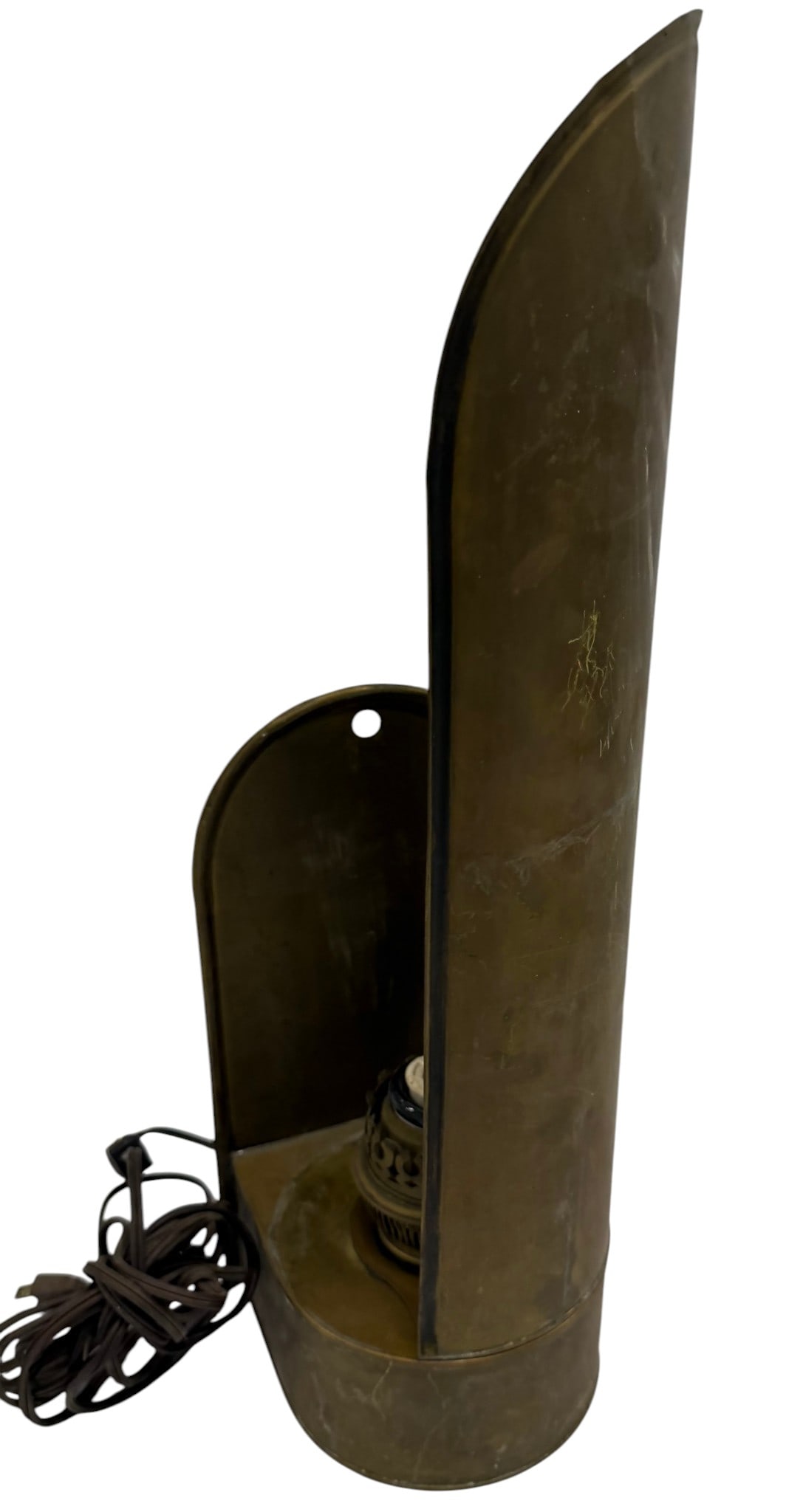 Vintage Brass Wall Sconce Lamp: A vintage brass wall sconce lamp, likely from the mid-20th century, offering a rustic or industrial aesthetic. The sconce features a curved brass shield that directs light upwards or outwards,