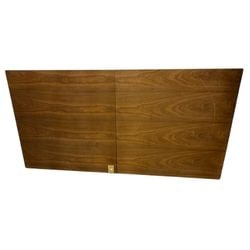 Mid-Century Modern Extendable Dining Table with Walnut Veneer: An extendable dining table, likely from the Mid-20th Century, showcasing a rich walnut venner top with distinctive grain patterns. The table features a butterfly leaf extension mechanism, allowing