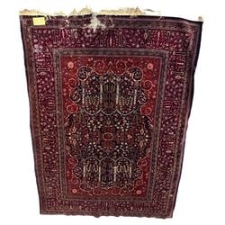 Antique Persian Kerman: This antique Persian Kerman rug features a rich, intricate floral medallion design set against a deep red and navy blue ground. The border displays complementary floral motifs. Hand-knotted from
