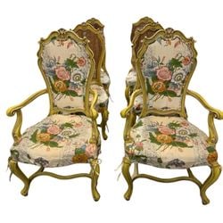 Set of Six Giltwood and Caned Bergere Chairs with Floral Upholstery: A charming set of four giltwood bergere chairs, likely Continental European from the mid-20th century, embodying a sophisticated Rococo Revival style. Each chair features a gracefully carved giltwood 