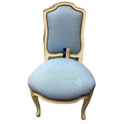 French Louis XVI Style Painted Fauteuil with Blue Upholstery: A French Louis XVI style fauteuil, featuring a painted cream frame and blue upholstered seat and backrest. The chair is characterized by its elegant, curved lines, cabriole legs, and ornate carving de