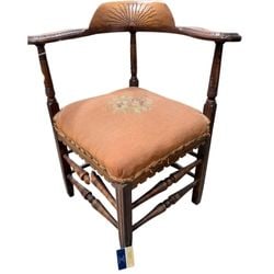Victorian Corner Chair with Rising Sun Motif: An antique Victorian-era corner chair, likely crafted from mahogany or walnut, featuring a distinctive rising sun carving on the top rail. The chair is characterized by its square form designed to