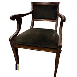 Regency Style Mahogany and Velour Armchair: A refined Regency style armchair, likely dating from the early 20th century, crafted from mahogany with intricate carved details. The chair features a rectangular back and seat, both upholstered in a