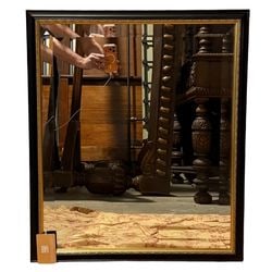 Contemporary Black and Gilt Framed Mirror: A contemporary wall mirror featuring a sleek black frame with a decorative gilt-painted inner edge, adding a touch of classic elegance. The mirror provides a clear reflection and is set within a