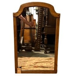 Carved Oak Wall Mirror, Early 20th Century: An attractive mirror from the early 20th century, likely 1910s-1930s, featuring a carved oak frame. The mirror boasts a traditional design with an arched top and gently scalloped shoulders,