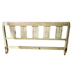 Carved and Painted Neoclassical Style Headboard: A Neoclassical style headboard, likely dating from the mid-20th century, crafted from wood with a distressed, painted finish in a light green/cream hue. The headboard features an elaborately carved