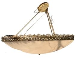 Large Neoclassical Style Alabaster and Gilt Bronze Chandelier: A substantial Neoclassical style chandelier with a large, inverted dome-shaped alabaster diffuser bowl. The bowl is suspended by a decorative gilt bronze frame featuring classical motifs such as