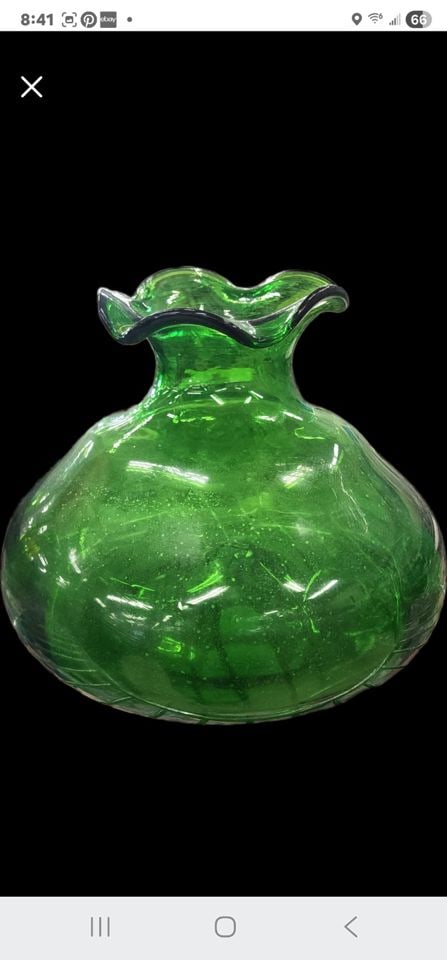 Vibrant mid-century hand-blown emerald green art glass vase, likely by Anchor Hocking. 10" Diam 8"h: This is a hand-blown emerald green glass vase with a distinctive ruffled top edge and a rounded shape. The vase is believed to be manufactured by Anchor Hocking. It is suitable for displaying flowers 