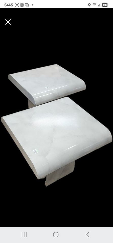 A striking pair of sculptural faux marble postmodern side tables from the late'80s: A striking duo of postmodern side tables from the late 1980s, featuring a sculptural waterfall-edge top and monolithic pedestal base. Finished in faux-stone laminated formica Carrara-style surface, th