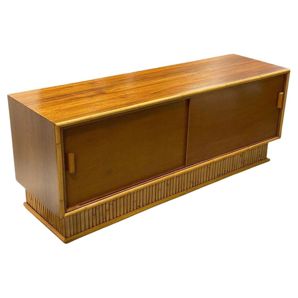 Restored Frankl Style Rattan & Mahogany Credenza TV Stand W/ Stacked Rattan Base: Title: Restored Frankl Style Rattan & Mahogany Credenza TV Stand W/ Stacked Rattan Base Description: Restored Mid-century mahogany credenza with a stacked rattan base designed after the furniture