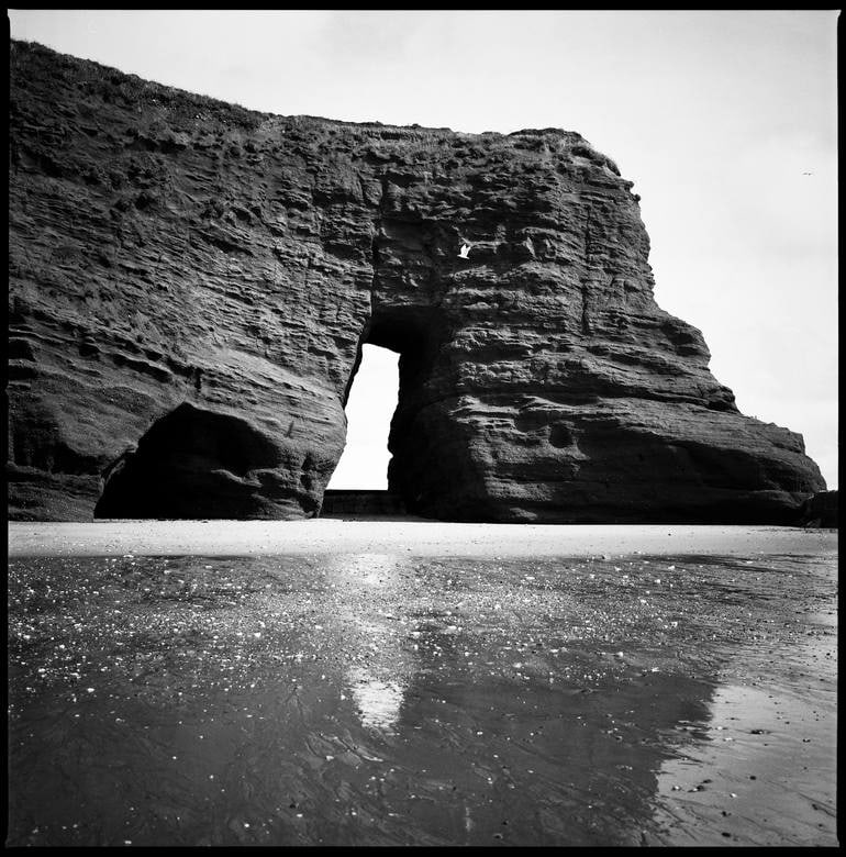 Langstone Rock At Dawlish Warren, Devon - Silver Gelatin Photograph: Title: Langstone Rock At Dawlish Warren, Devon - Silver Gelatin Photograph Description: 20 x 20 in Medium: Langstone Rock at Dawlish Warren, Devon - Silver Gelatin Photograph - Limited Edition of 10